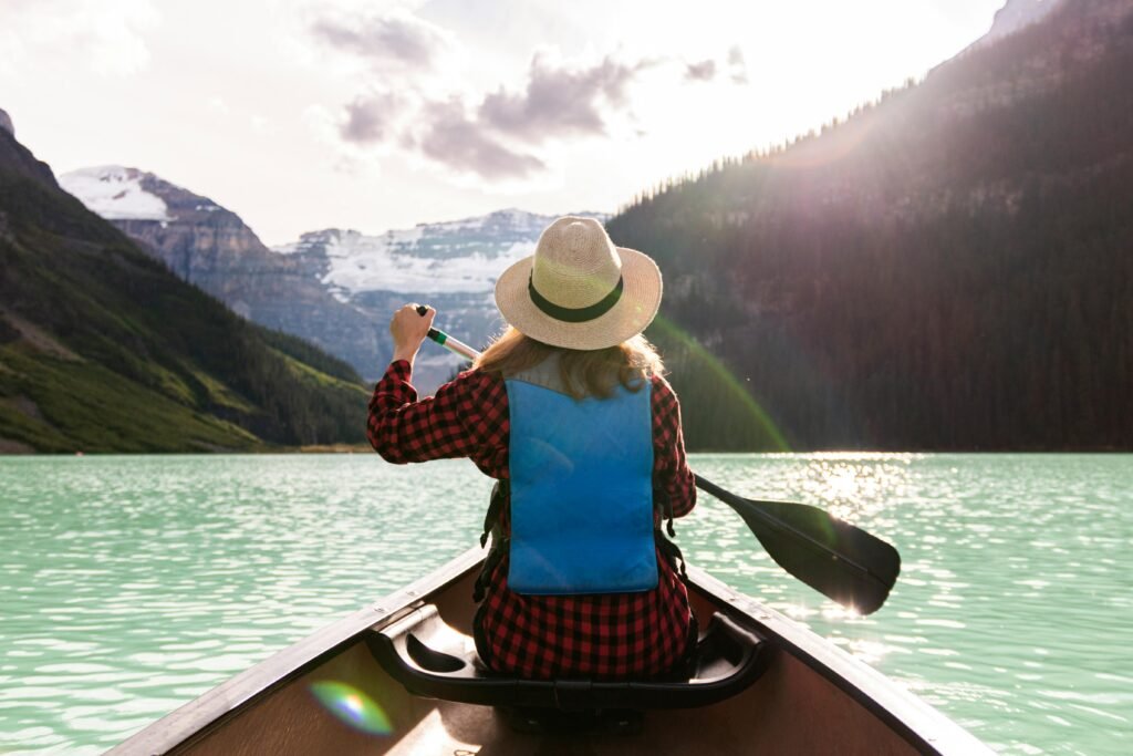 A woman is riding a canoe in Lake Louise Alberta