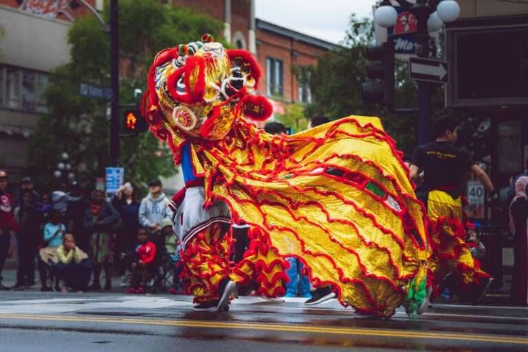 Vibrant dragon dance performance during a street parade in Chinatown Victoria, BC, Canada, celebrating cultural heritage.