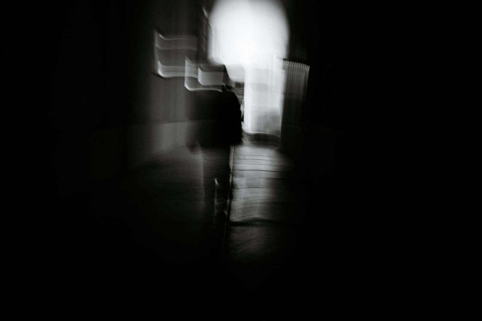 Artistic blurred silhouette in a dark tunnel setting, conveying mystery.